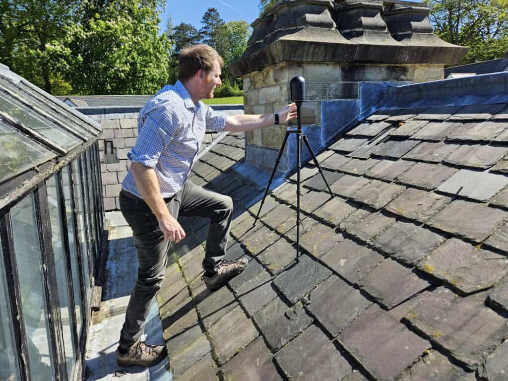 Laser scanner set up on a pitched roof of a Listed building